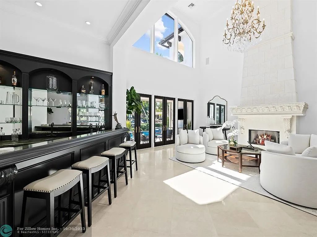 A living room with a fireplace and a bar.