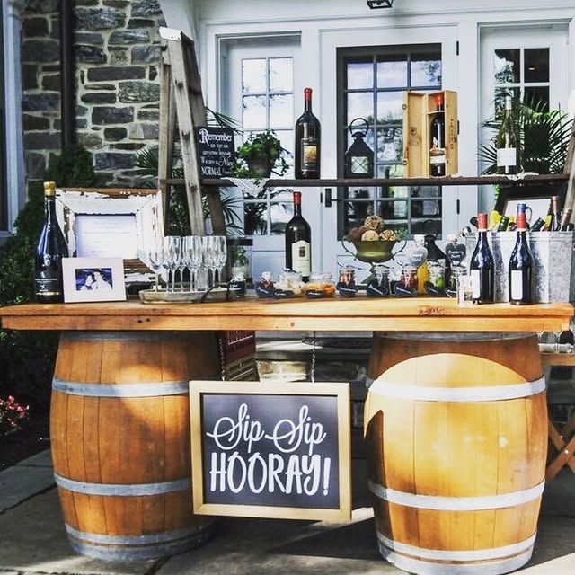 A wooden bar with a sign that says sip sip hooray