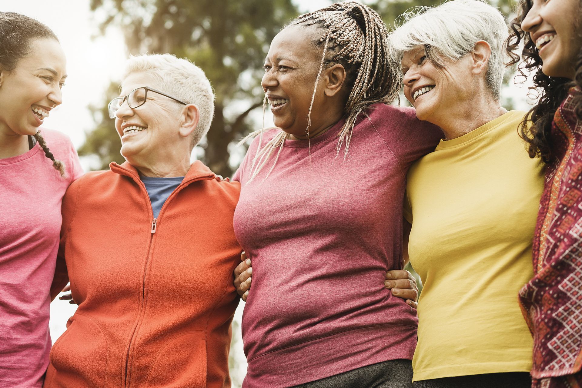 A group of women are standing next to each other and hugging.