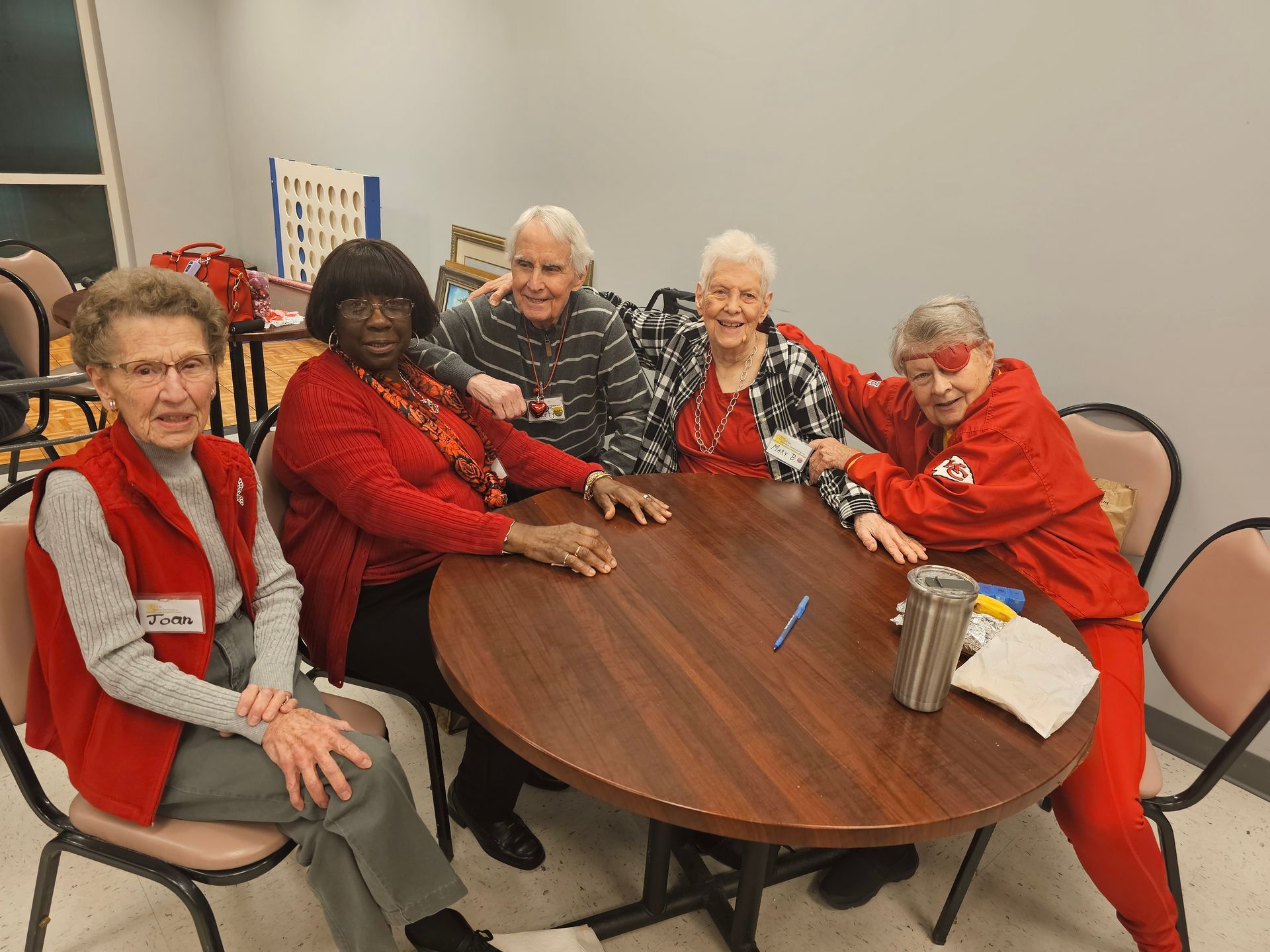 A group of older women are sitting around a table.