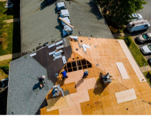 Roofers in Cheyenne removing old roof shingles and replacing with new shingles.