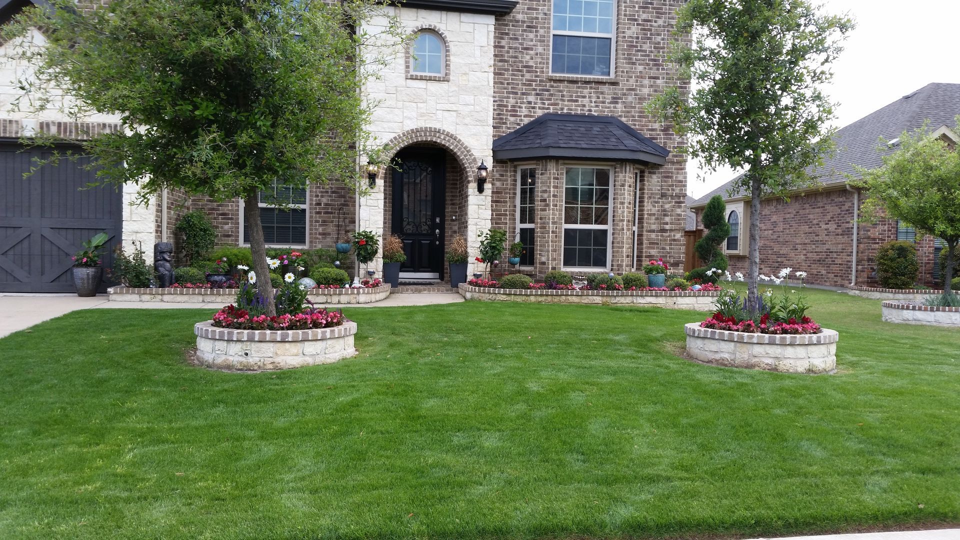 A large house with a lush green lawn in front of it.