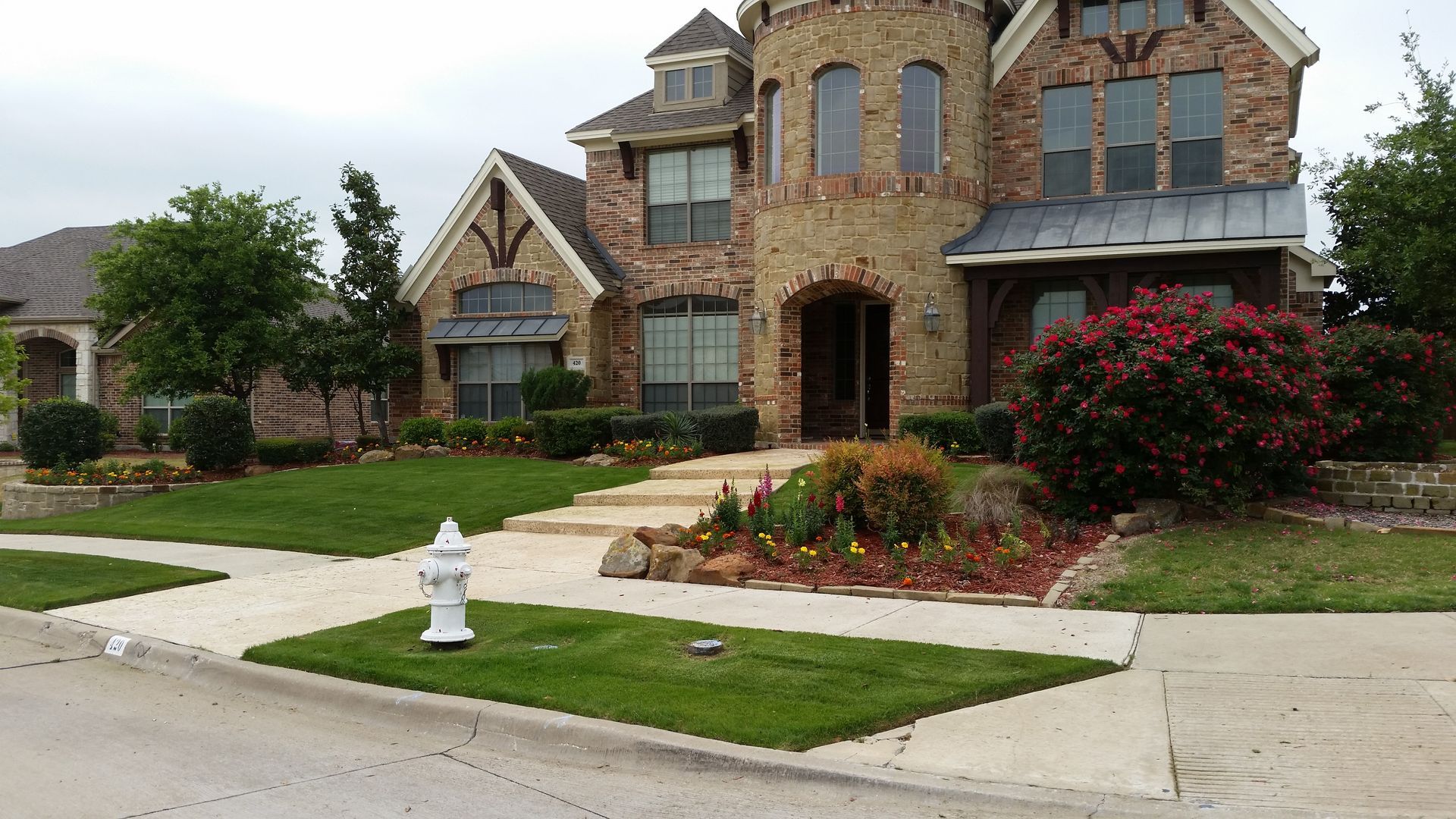 A large brick house with a fire hydrant in front of it