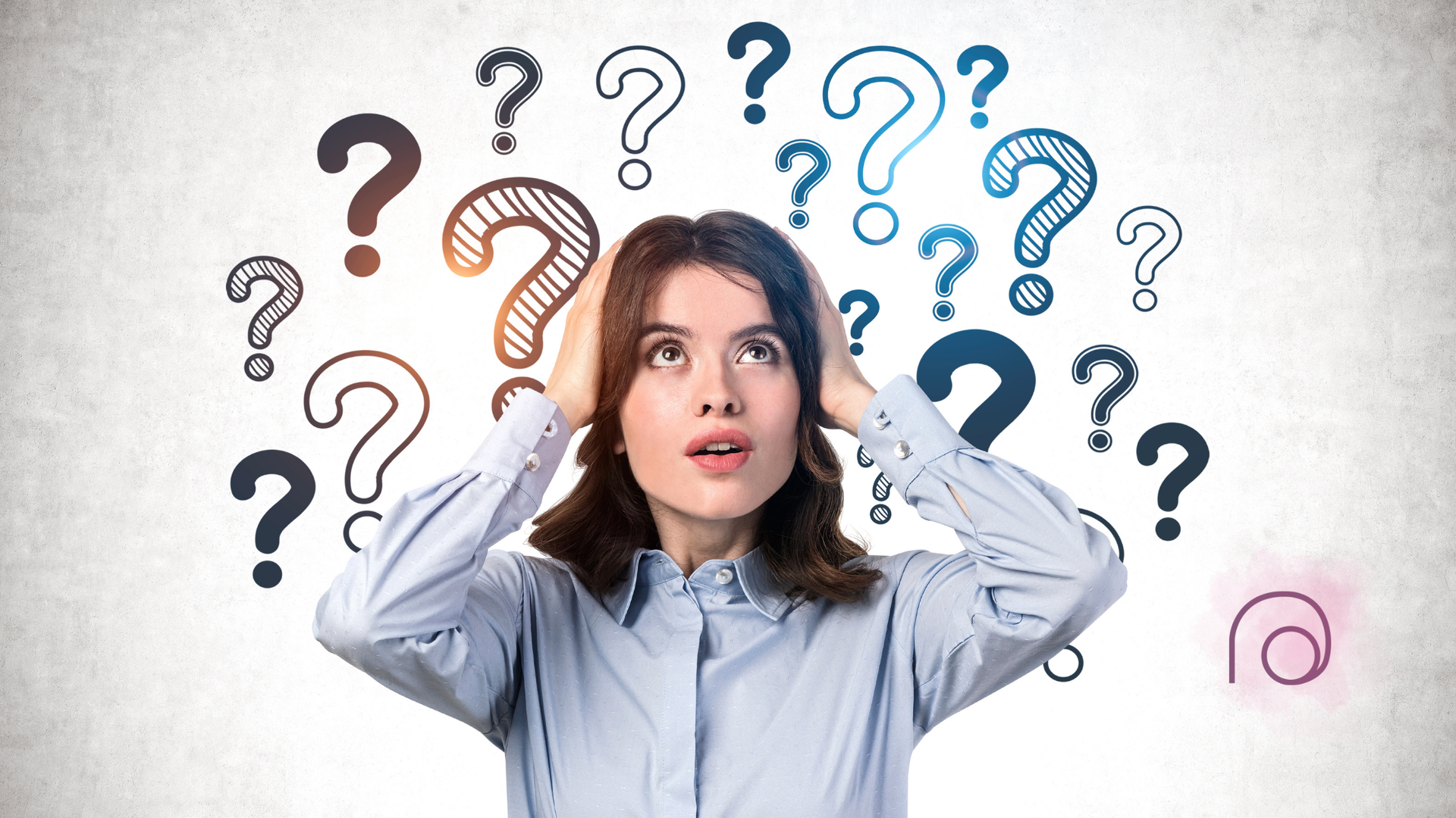 A woman is surrounded by question marks on a wall.