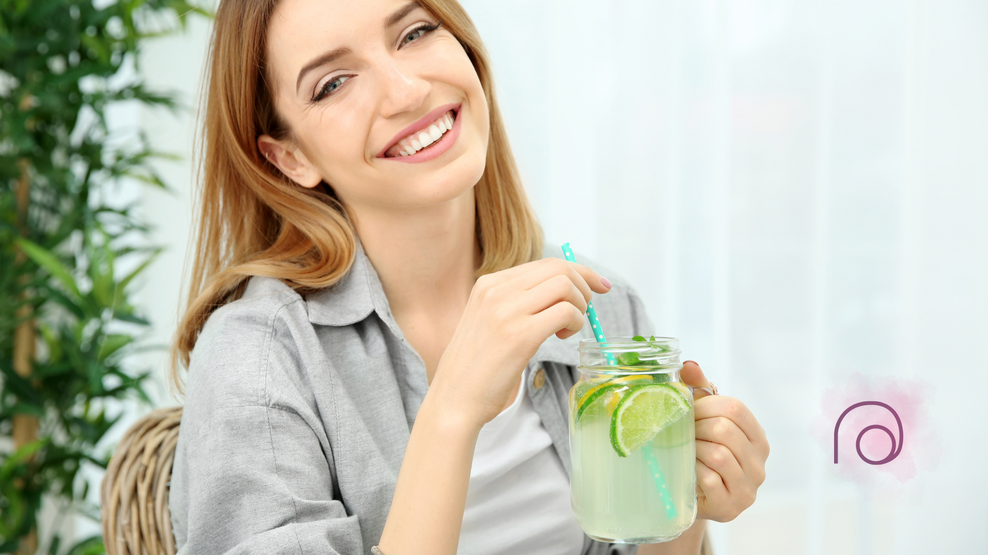 A woman is drinking a smoothie with a straw.