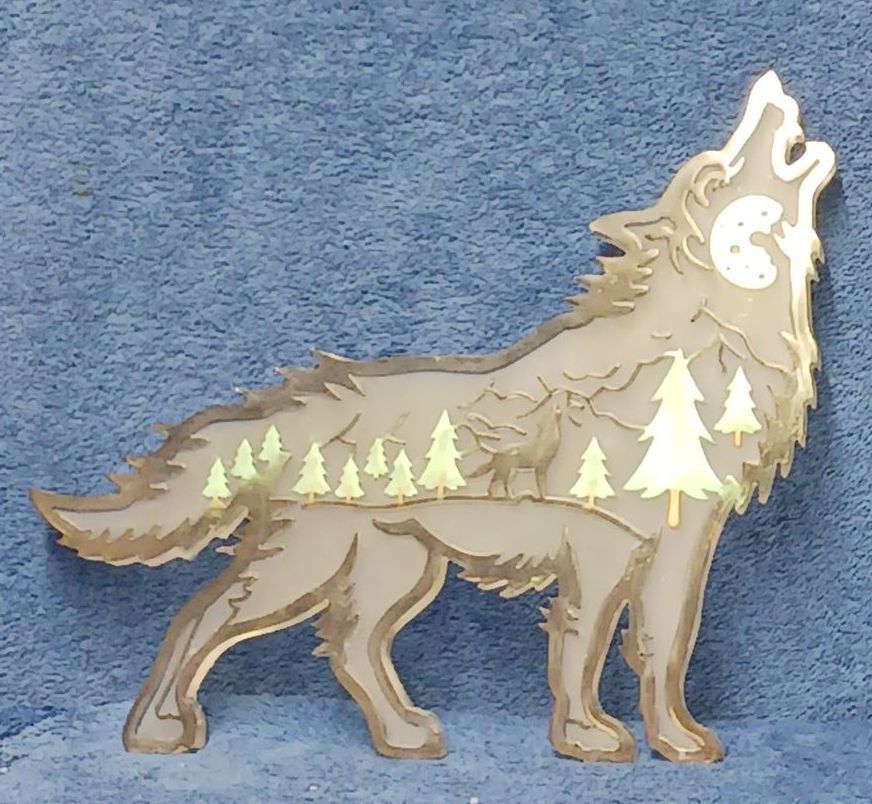 A resin wooden wolf howling with trees in the background