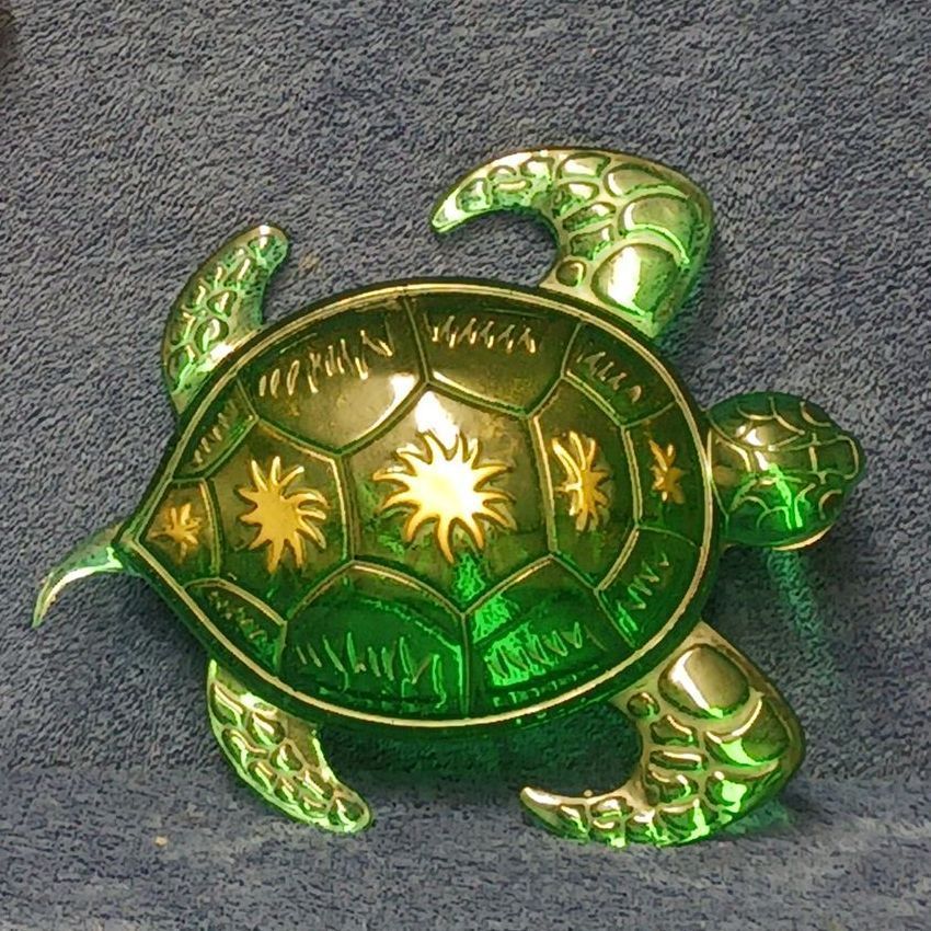 A resin green turtle with gold stars on its shell