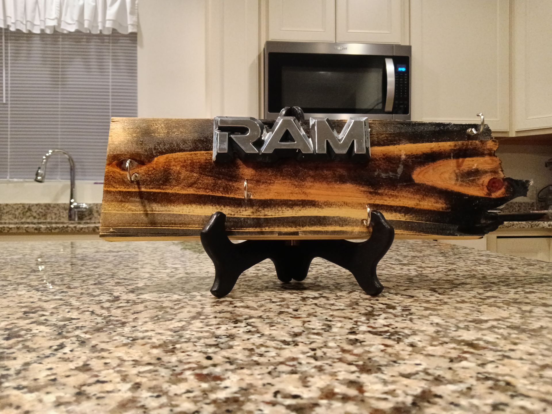 A ram sign is sitting on a granite counter in a kitchen