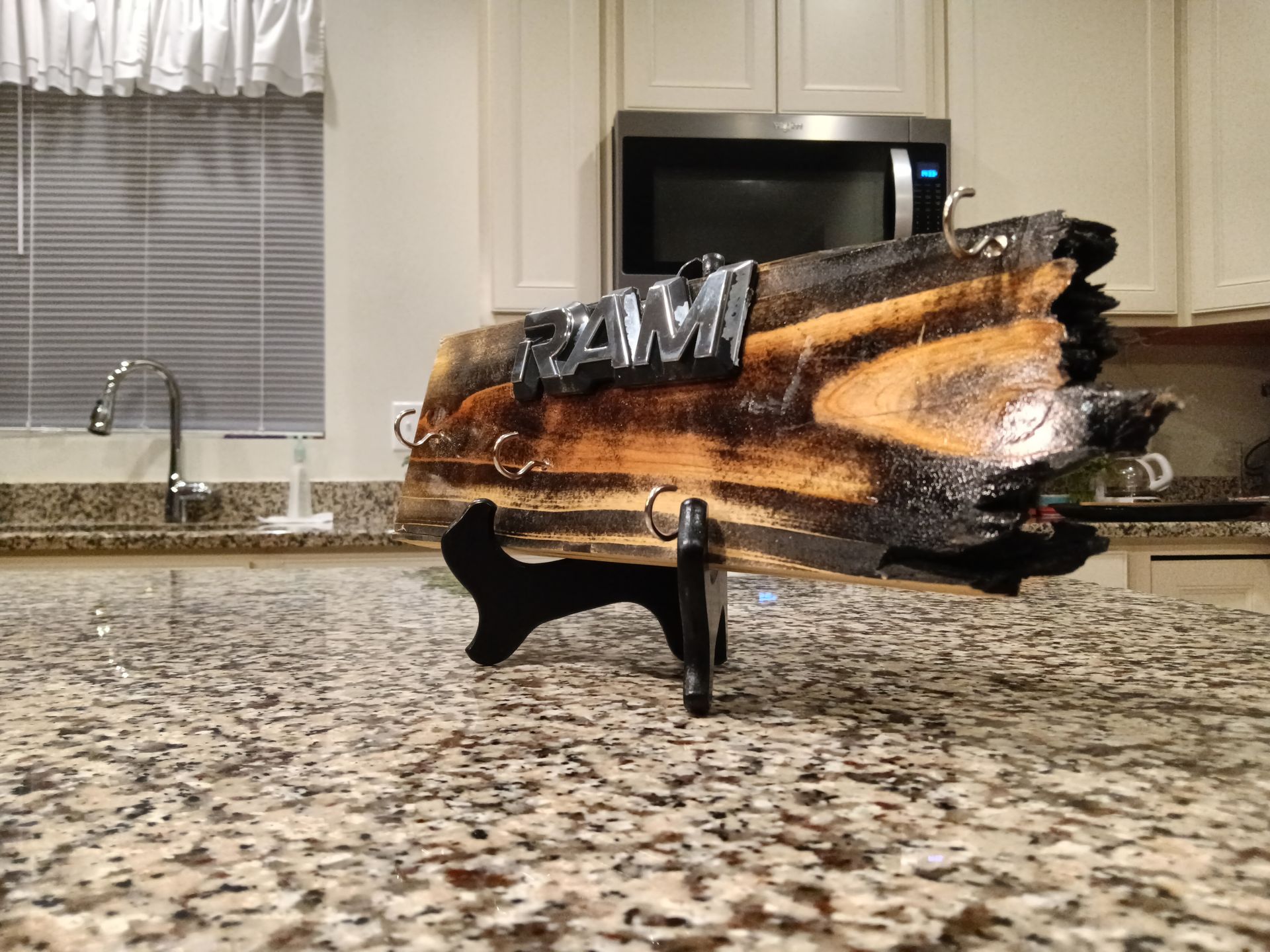 A ram sign is sitting on a granite counter in a kitchen