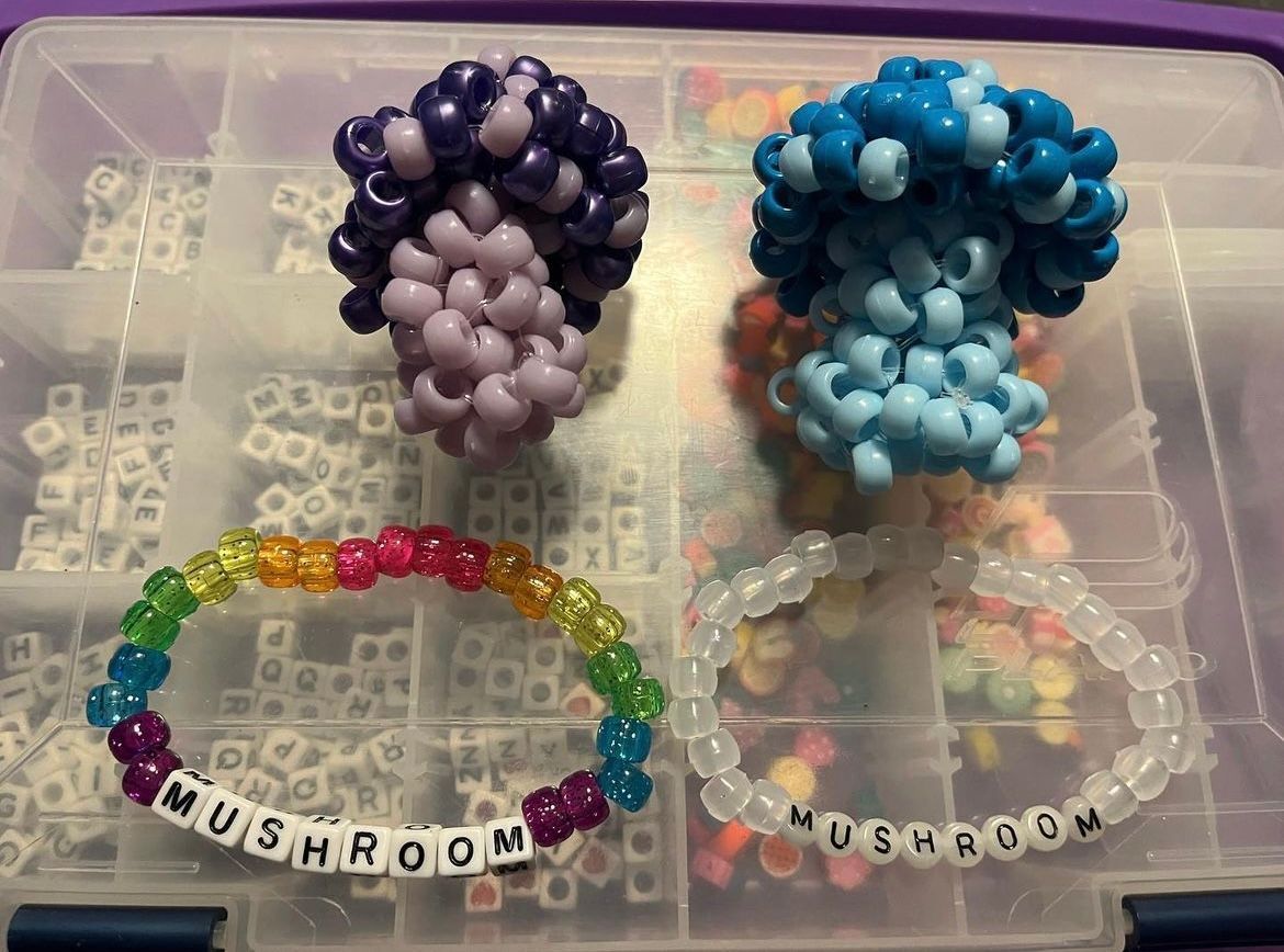 Two bracelets made of beads with the word mushroom on them