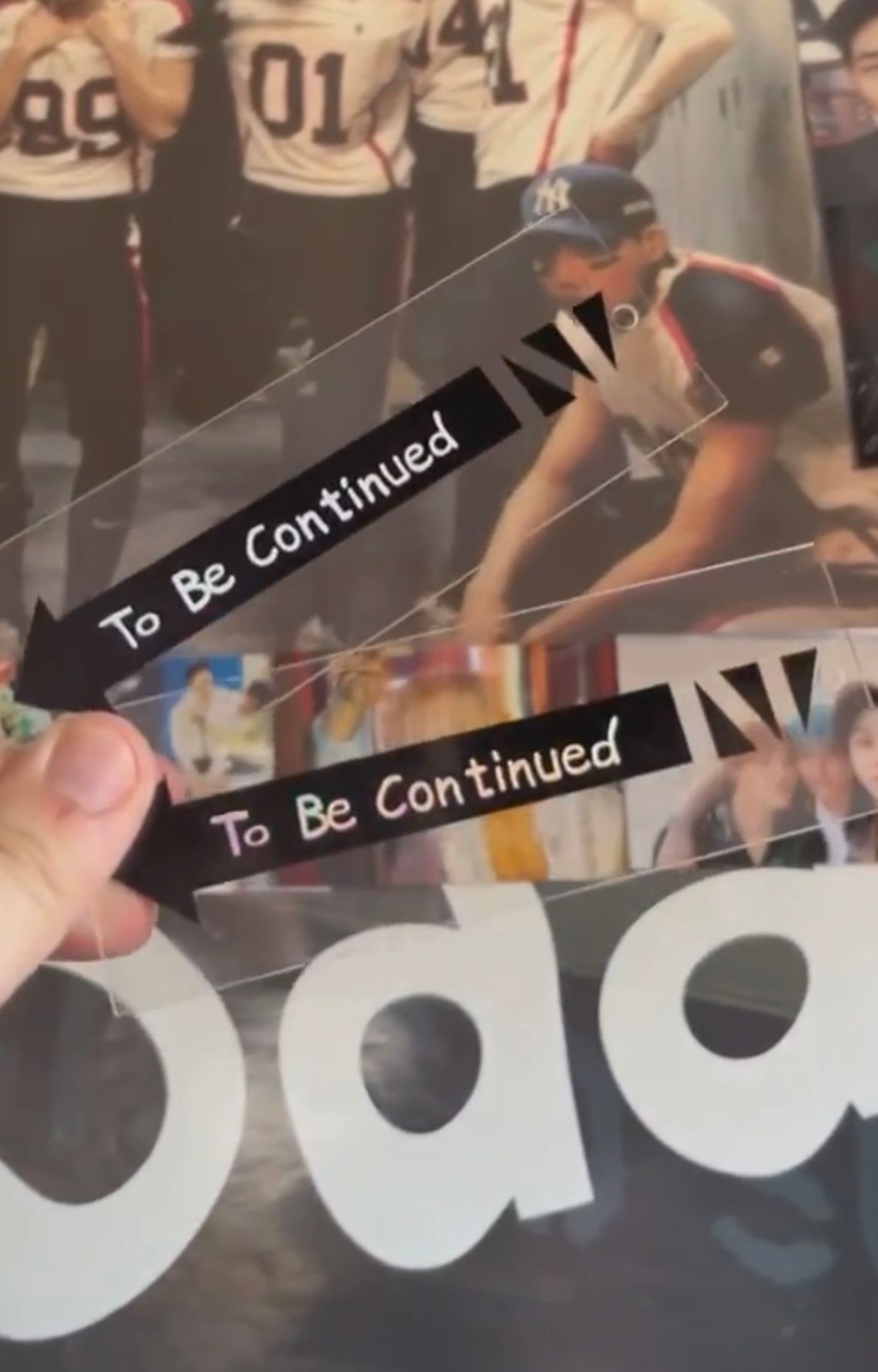 A person is holding a piece of paper that says to be continued