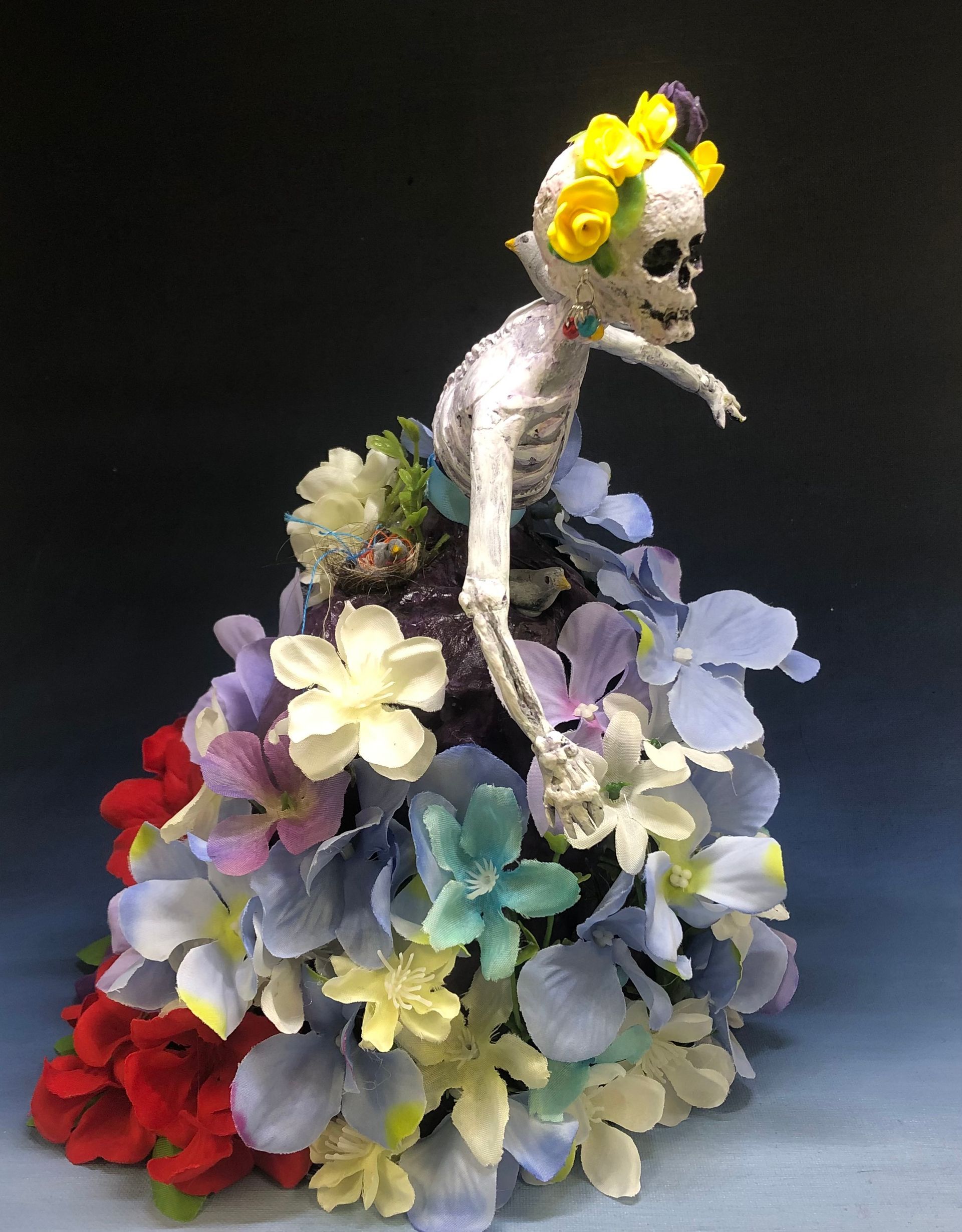 a skeleton in a dress with flowers on it