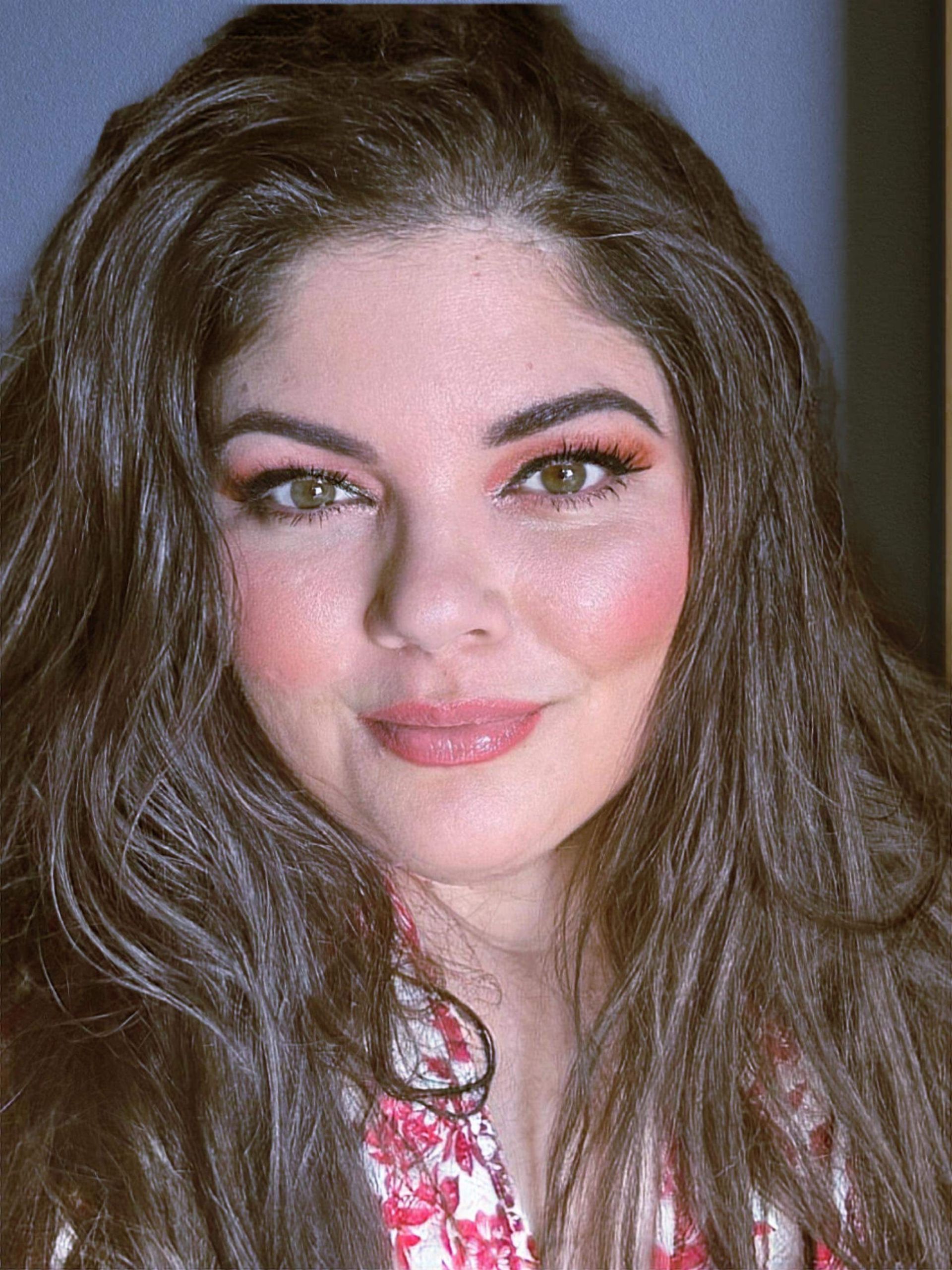 A close up of a woman 's face with long hair