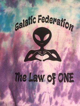 A tie dye shirt with an alien making a heart with his hands.