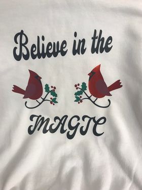 A shirt that says believe in the magic with two cardinals on it