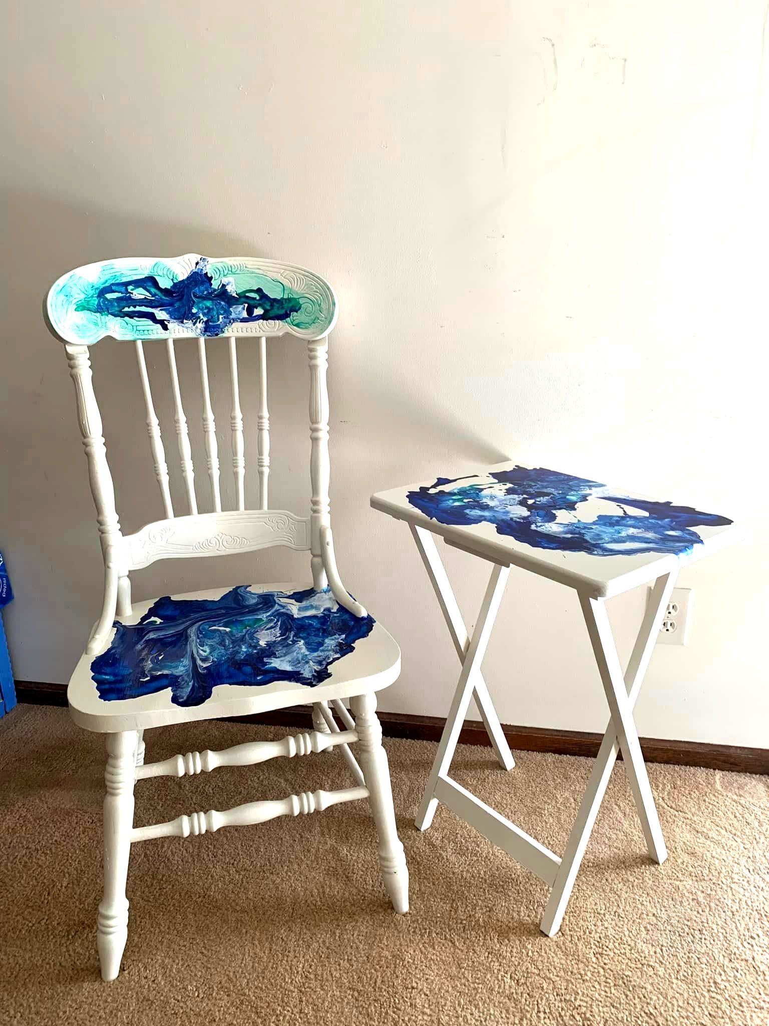 A chair and a table are sitting next to each other in a room.