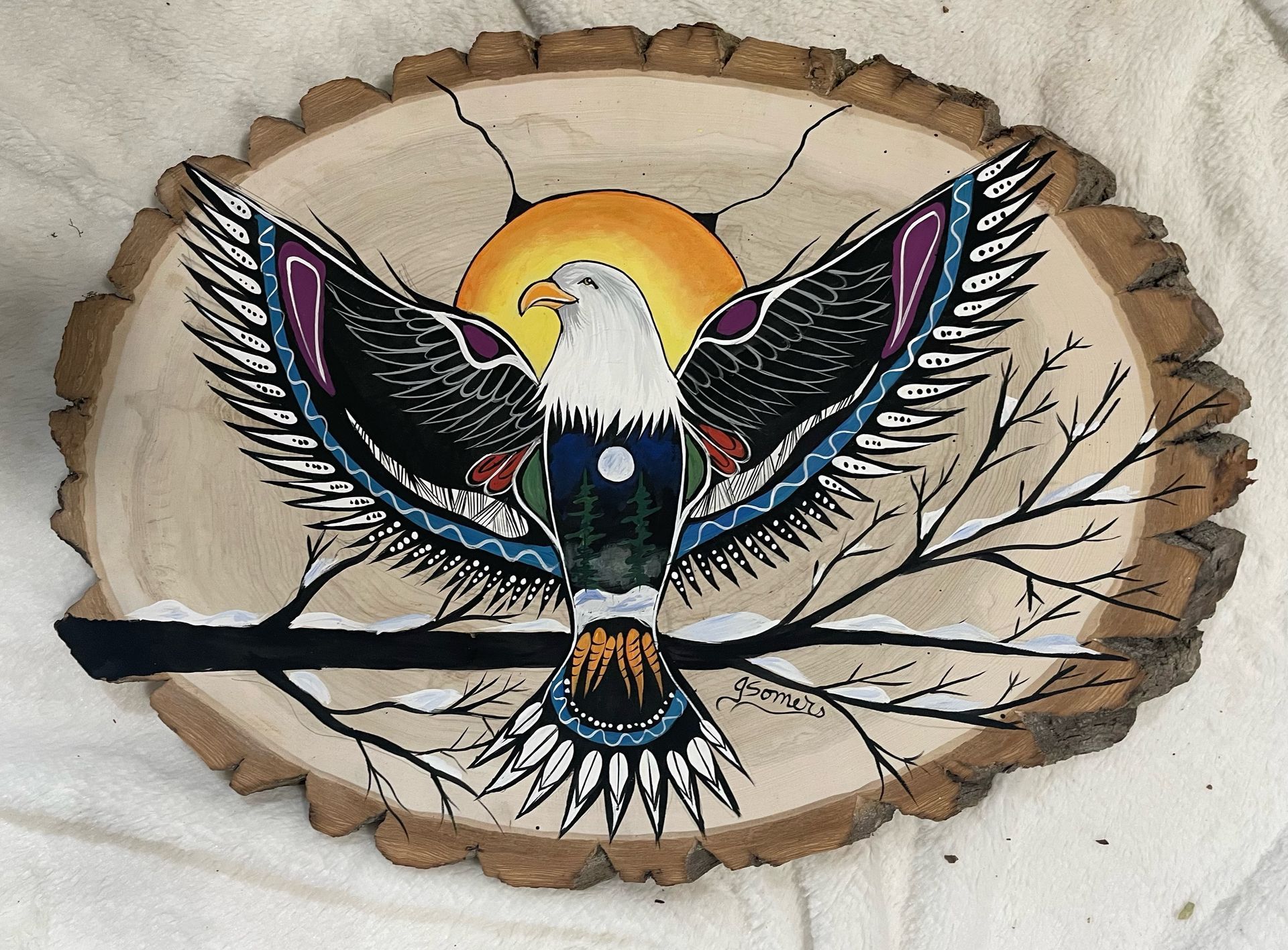 A painting of an eagle on a piece of wood