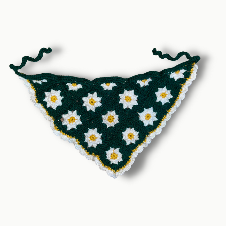 A green bandana with white and yellow daisies on it