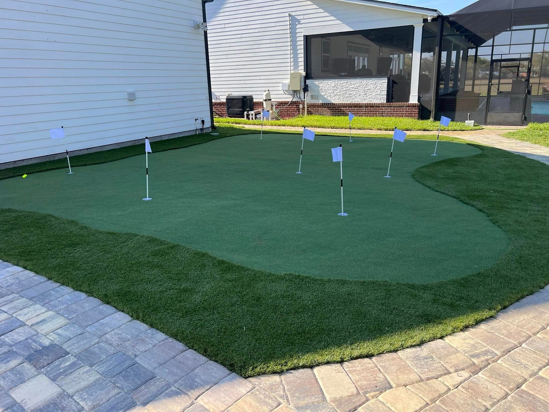 There is a putting green in front of a house.