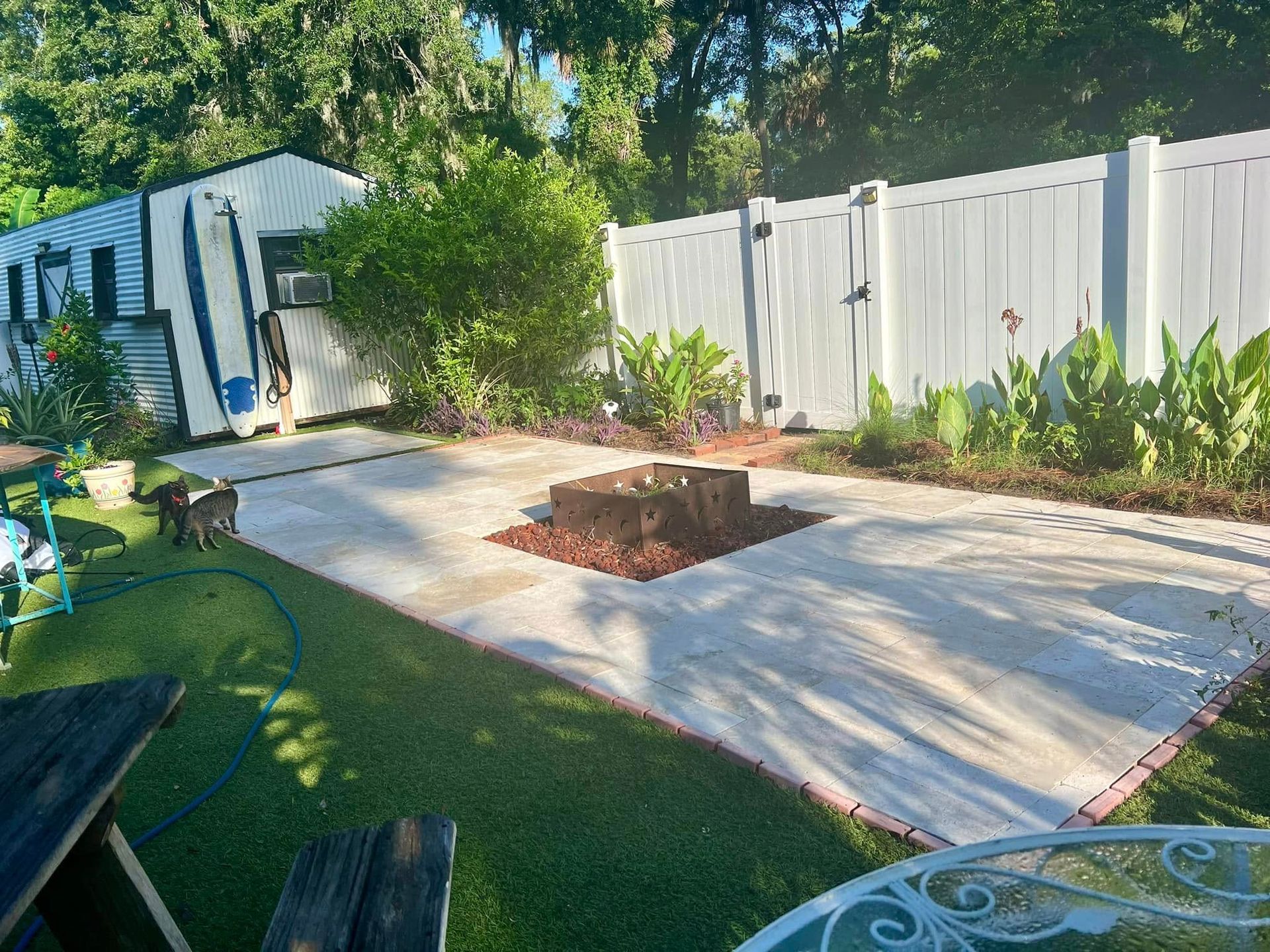 There is a fire pit in the middle of the backyard.