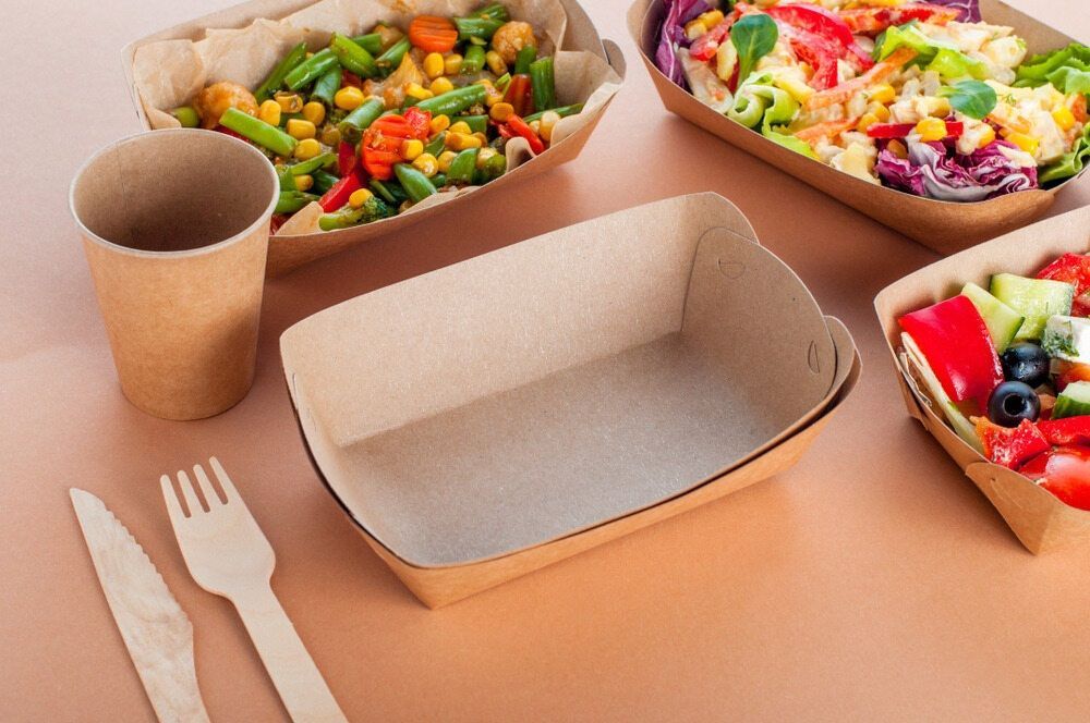 A Table Topped With Trays Of Food And Utensils — Café and Restaurant in Whitsundays, QLD