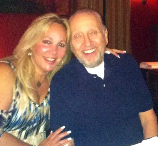 A man and a woman are posing for a picture together