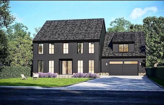 Black two-story house with a gray shingle roof, garage, and light-colored trim; surrounded by a lawn and trees.