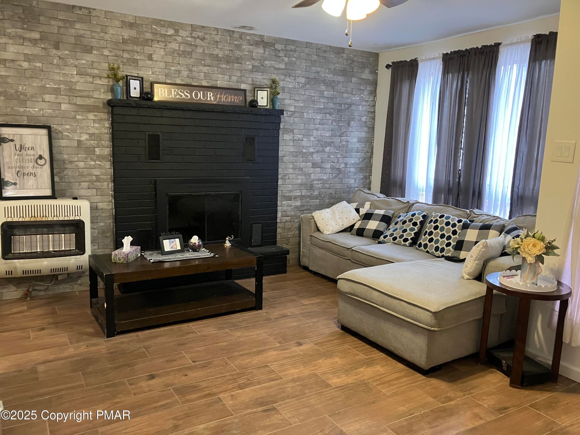 A kitchen with white cabinets and a large island in the middle.