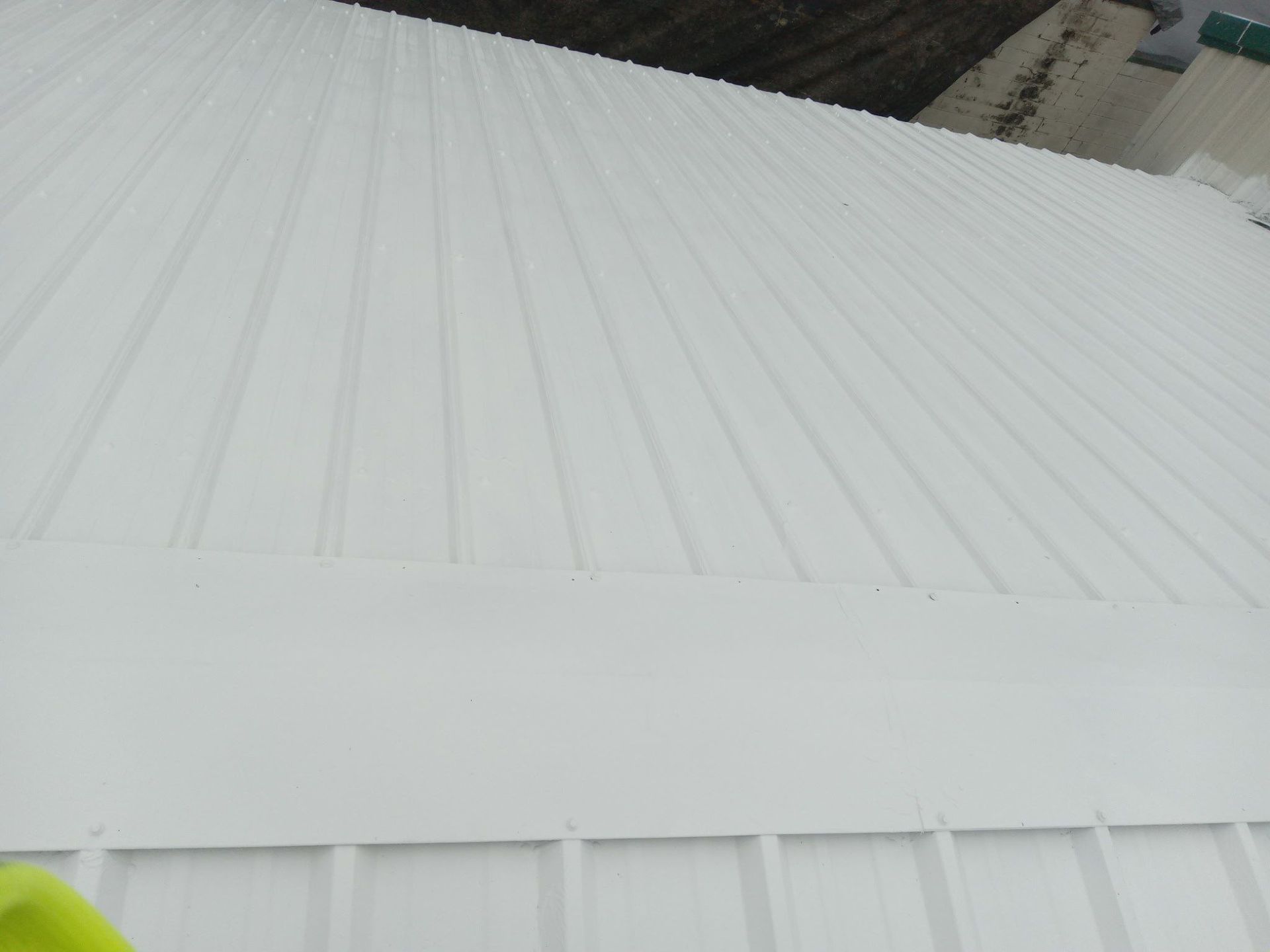 White metal roof with vertical ridges.