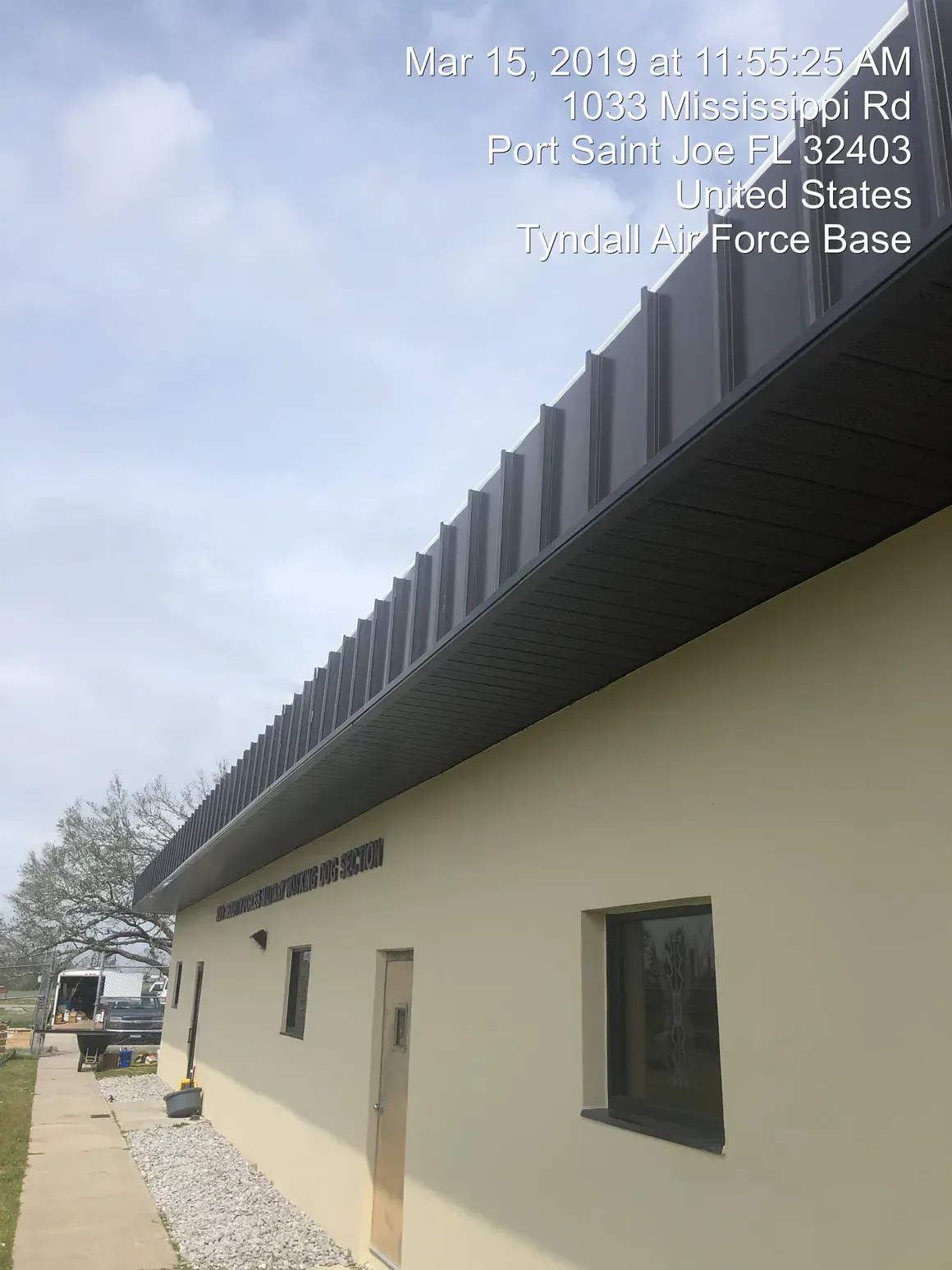 Building with dark metal roof, Port Saint Joe, Florida. Includes windows and text: Tyndall Air Force Base.