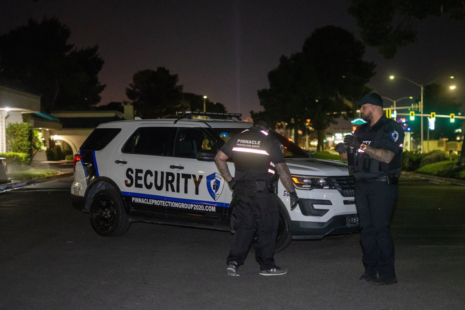 two security vehicle is parked in front of a large building .