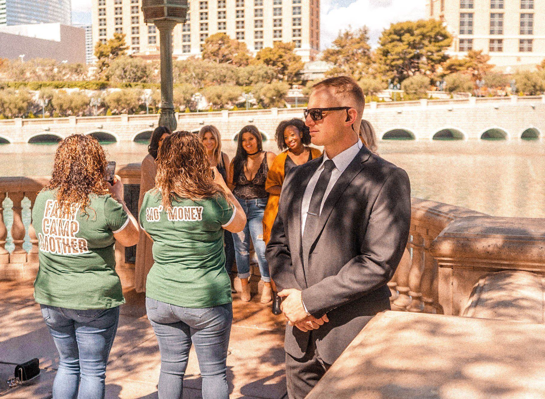 a man in a suit and tie is standing in front of a group of people .