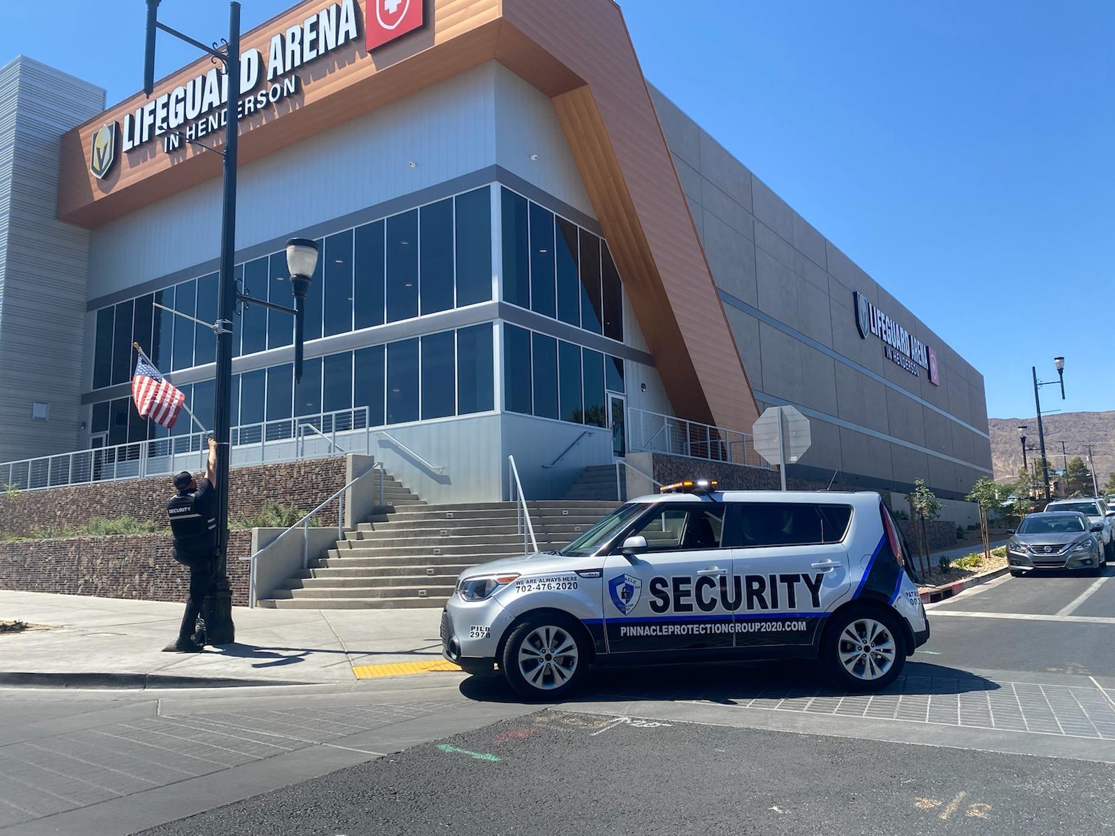 a security vehicle is parked in front of a large building .