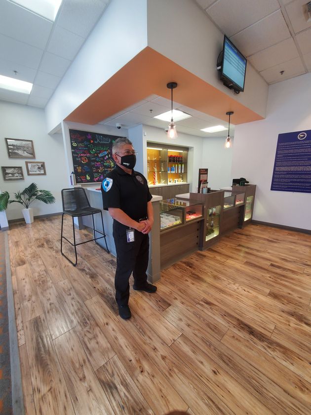 a police officer wearing a mask is standing in a store .