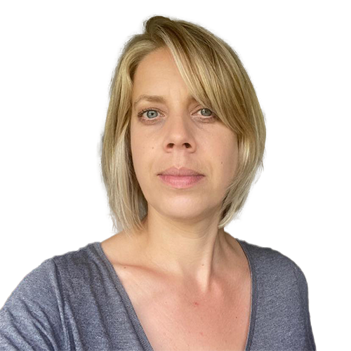 Blond woman with fair skin in a gray top looking directly at the camera.