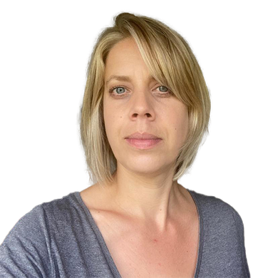 Blond woman with fair skin in a gray top looking directly at the camera.