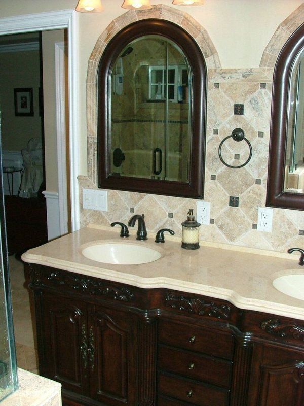 A bathroom with two sinks and two mirrors