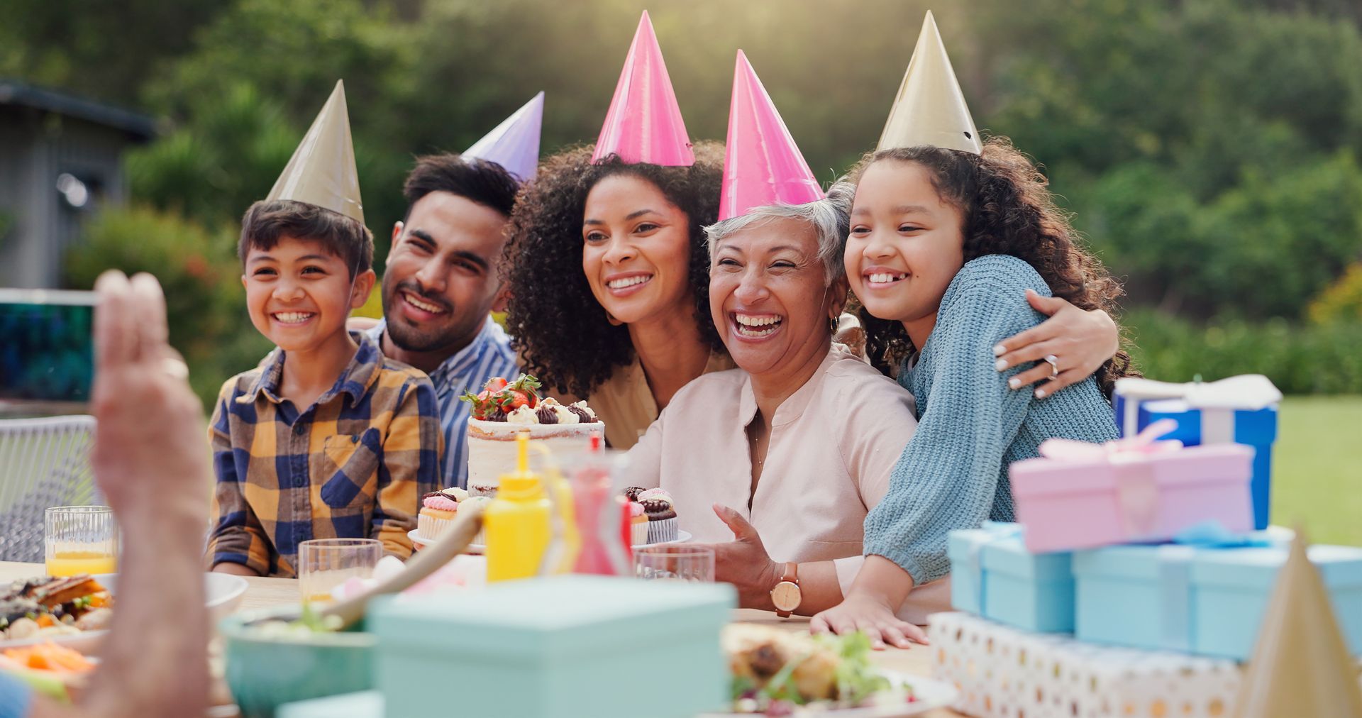 A family is posing for a picture at a birthday party.
