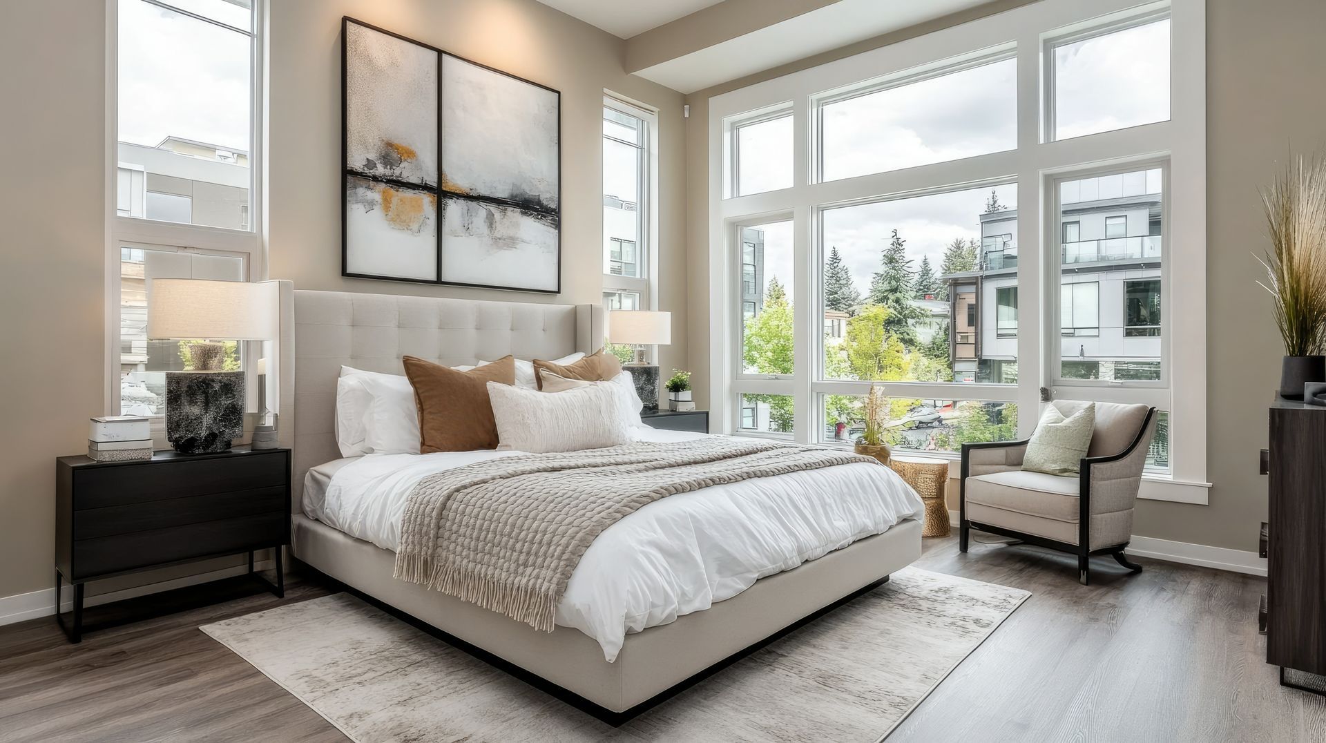 A bedroom with a large bed and lots of windows.