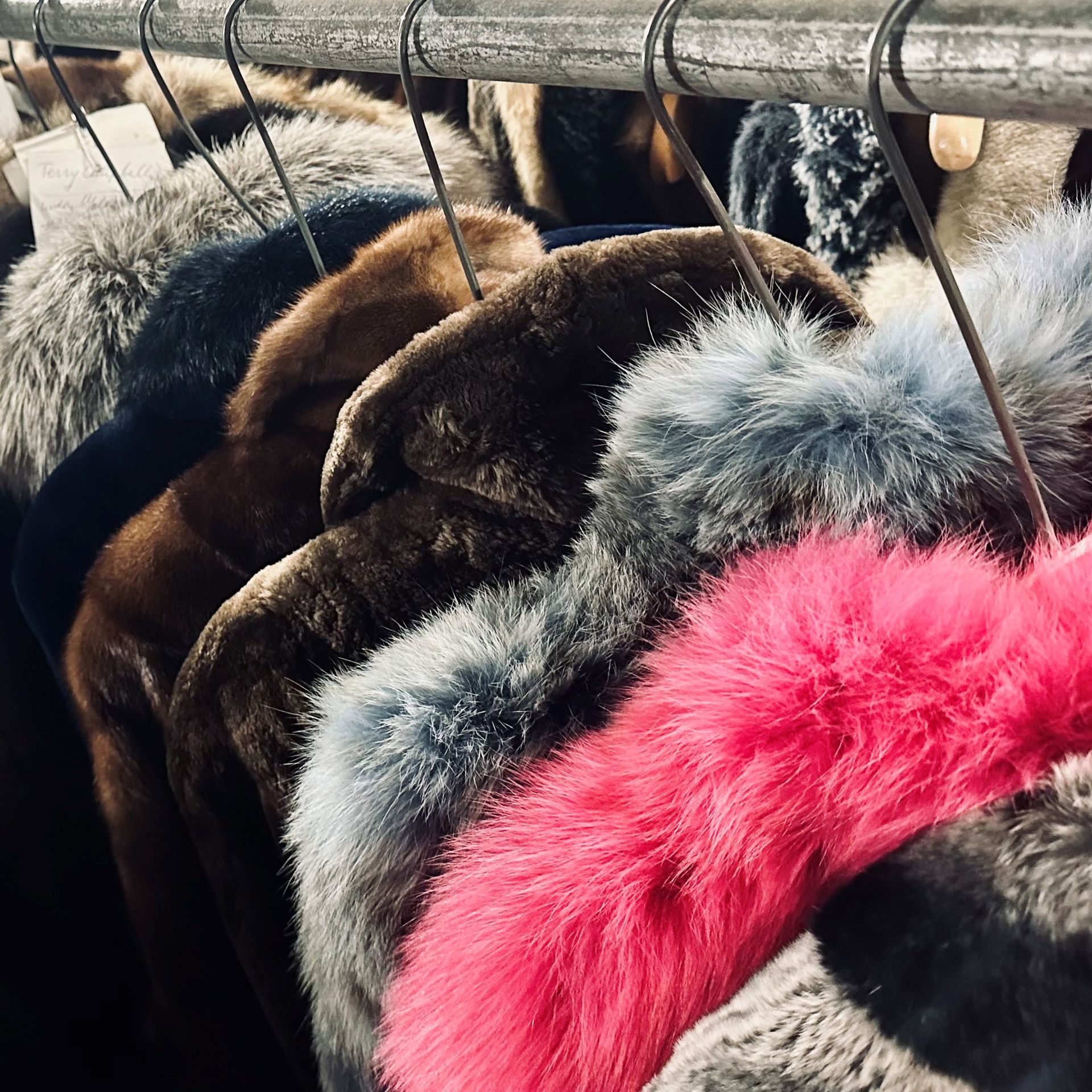 Three leather wallets are sitting on a wooden table.