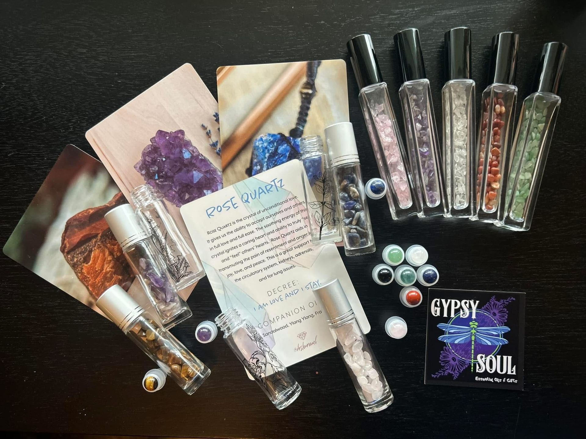 A gypsy soul card sits on a table surrounded by bottles and crystals