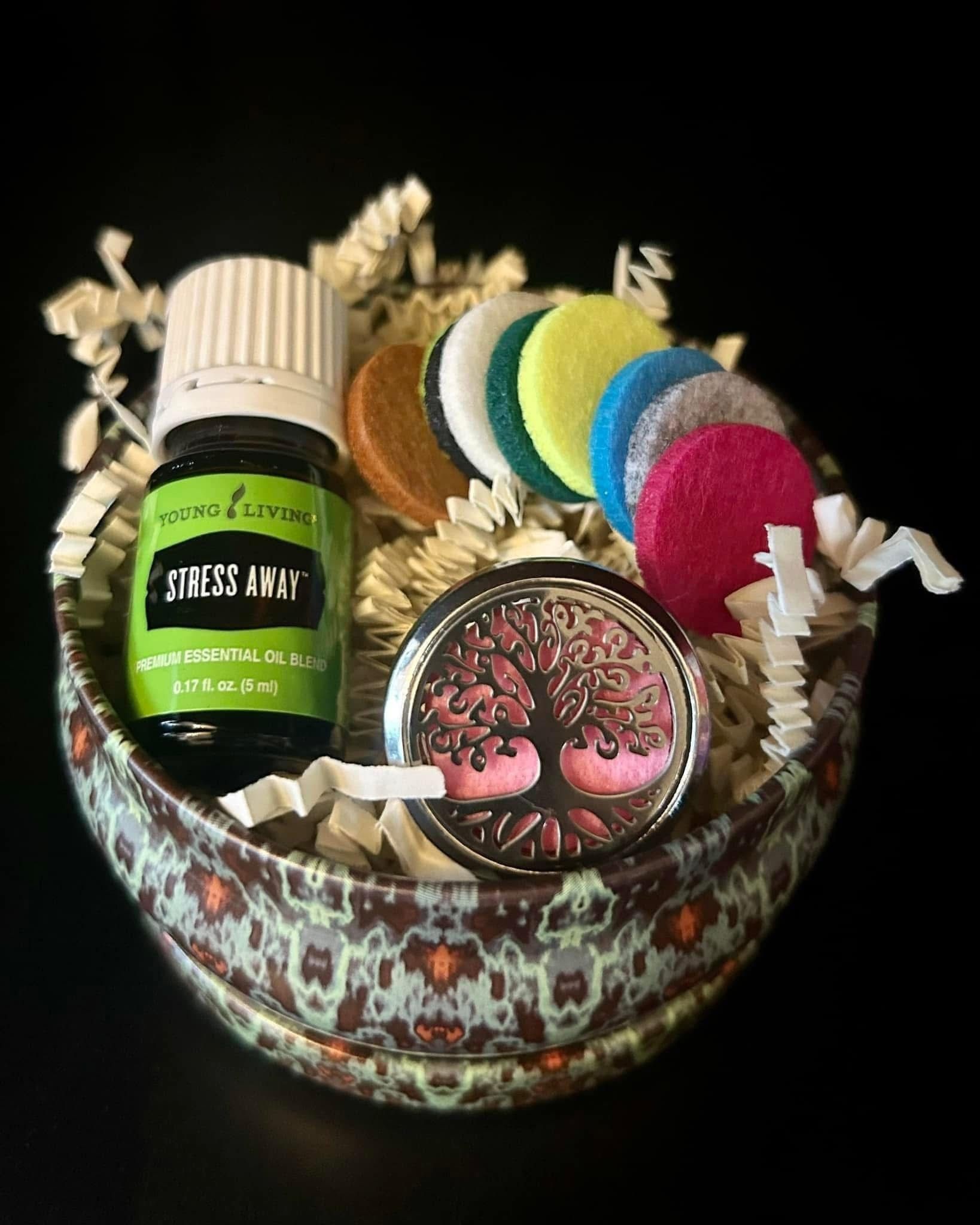 A bottle of essential oil is sitting in a bowl with other items.
