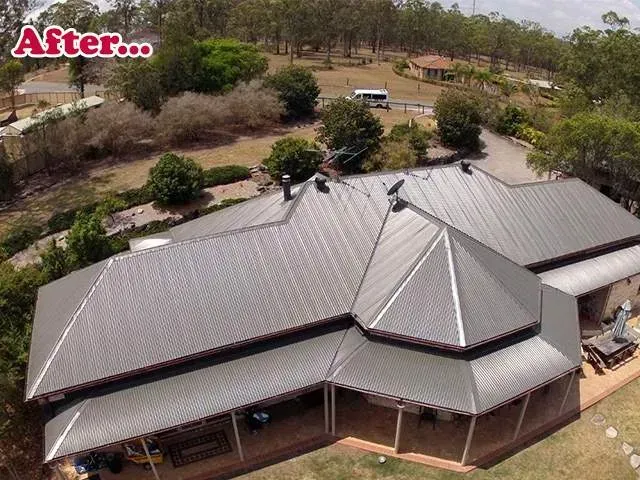 An aerial view of a large house with a metal roof