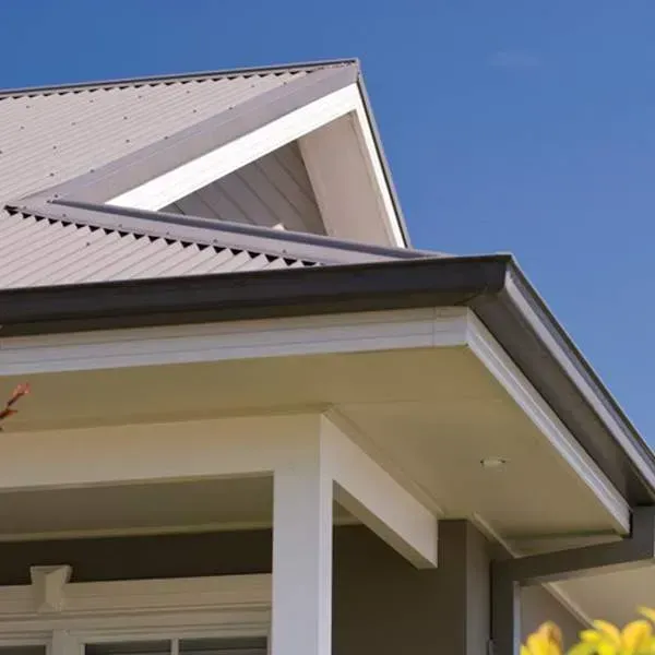 The roof of a house with a blue sky in the background