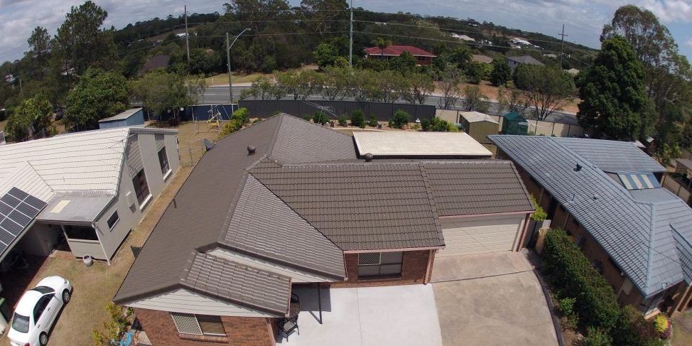 An aerial view of a residential area with houses and trees