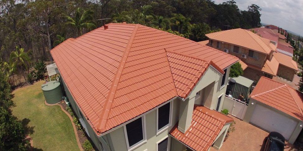 An aerial view of a house with a red tiled roof