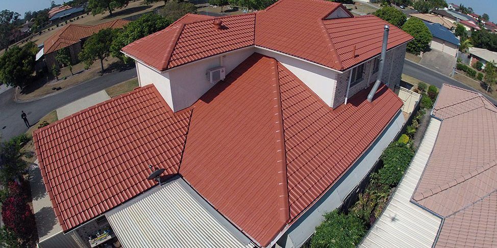 An aerial view of a house with a red tiled roof