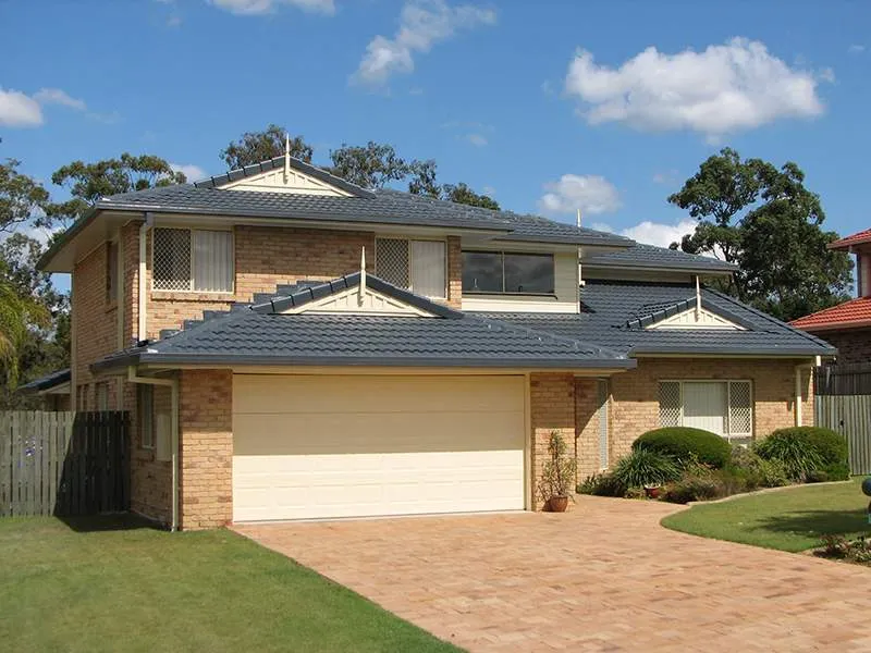 A large brick house with a white garage door