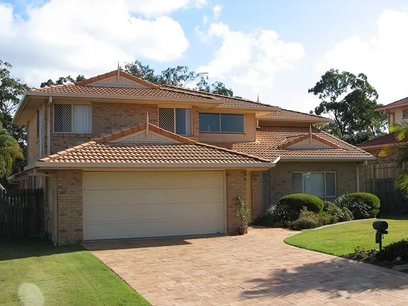 A large brick house with a white garage door