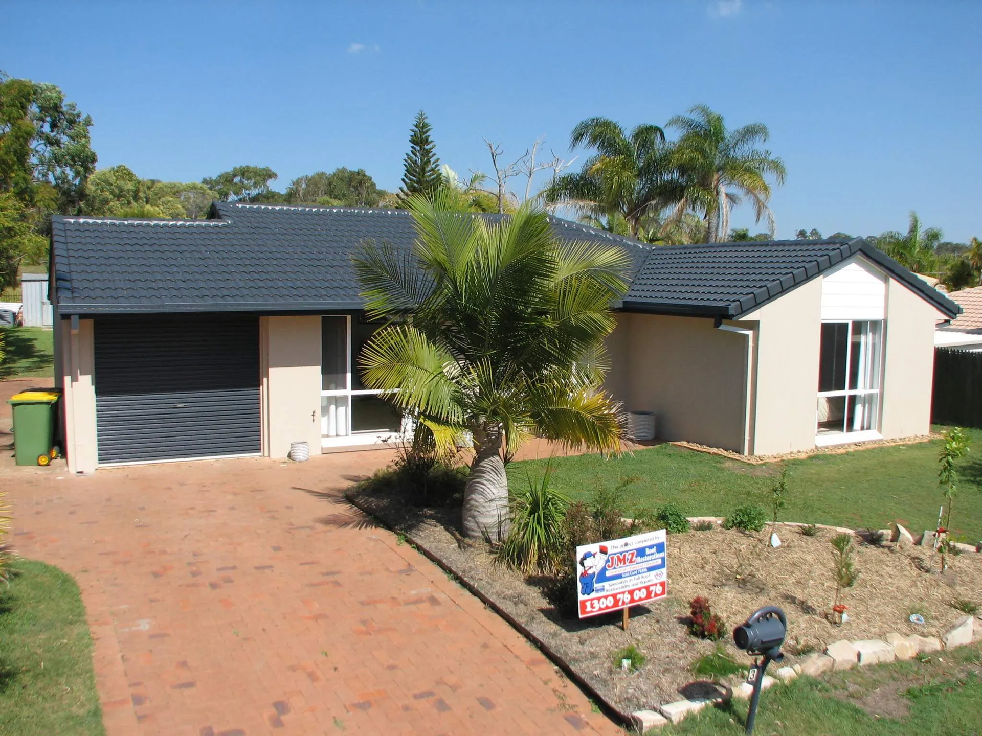 A house with a for sale sign in front of it